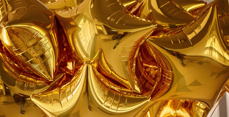 Fototapeta premium A cluster of shiny gold star-shaped balloons filling the room with festive cheer during a celebration