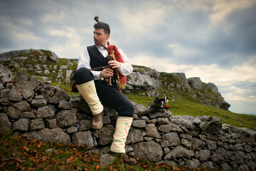 Bagpipe player in rural mountain location © michelangeloop
