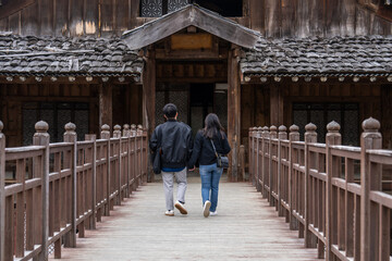 tourists walking to the old wooden building