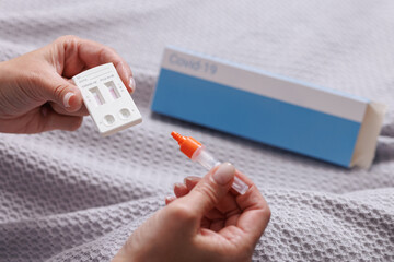 woman tests herself for new strain of coronavirus at home, covid-19 and flu virus test