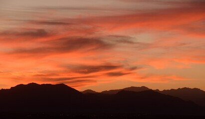 moody sunset over  colorado's front range  of the rocky  mountains  in autumn,  looking towards boulder, as seen from broomfield, colorado