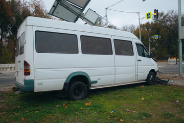 The broken bumper and hood of the car ended up with a pole. An accident occurred on the city street. Damaged cars. A serious accident.