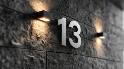 Illuminated number 13 on a textured concrete wall at night