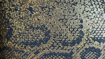 Opulent gold and blue brocade fabric, ideal for luxury fashion and upscale home decor. Perfect for designers and retail showcasing.