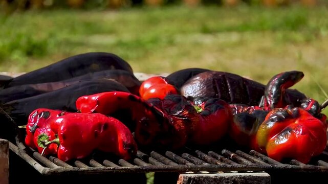 A rustic outdoor scene of vegetables grilling over a wood fire, an essential step in making traditional Romanian zacusca. The fire-roasted vegetables bring out deep, smoky flavors.