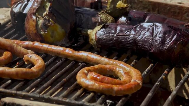 A rustic outdoor scene of vegetables grilling over a wood fire, an essential step in making traditional Romanian zacusca. The fire-roasted vegetables bring out deep, smoky flavors.