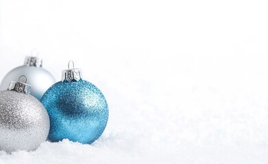 Blue and Silver Christmas Ornaments on White Snow Background