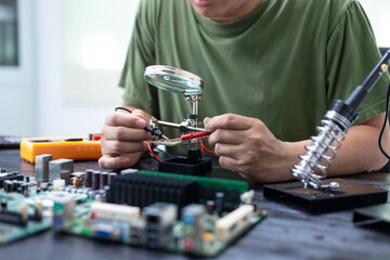 Technicians meticulously repair electronic components to turn them into precious gold. This process...