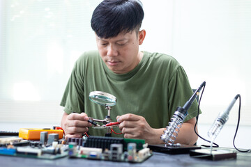 Technicians meticulously repair electronic components to turn them into precious gold. This process...