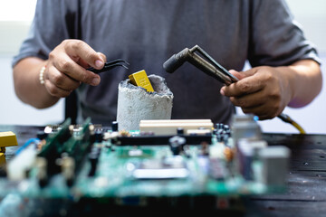 Technicians meticulously repair electronic components to turn them into precious gold. This process...