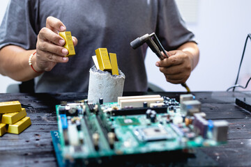 Technicians meticulously repair electronic components to turn them into precious gold. This process...