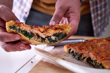 a piece of fish pie in the chef's hand. Close-up