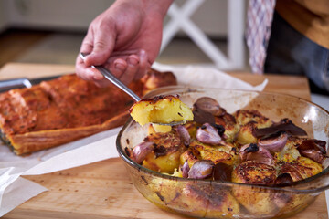 The cook is tasting a baked potato. Close-up