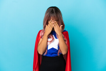 Young superhero woman with pink hair isolated on blue background with tired and sick expression © luismolinero