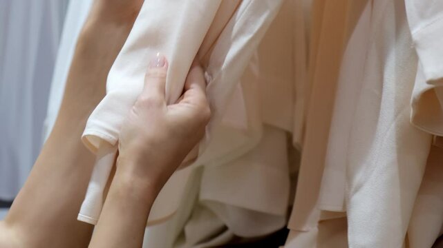 A young woman enjoys shopping in a clothing store, exploring new collections. This scene highlights the joy of selection and the desire to find the perfect outfits for any occasion.