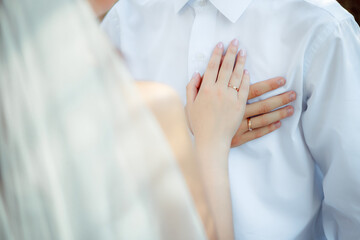 Wedding bouquet in the hands of the bride at the ceremony. Touching the hands of the bride and groom. Hugs of the newlyweds. Future married couple. The tenderness and beauty of the wedding ceremony.