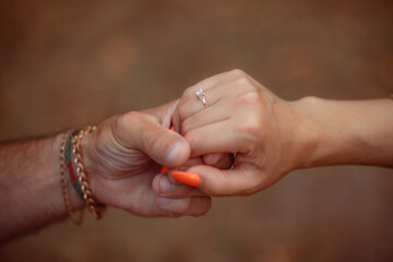 A couple in love touches each other with their hands. Love story of a young couple in love. Wedding...