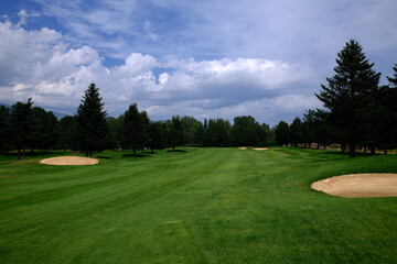 green golf course in a sunny day 