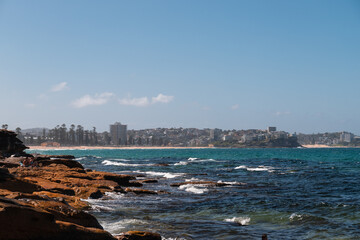 View of Manly beach as seen during a walk around the North Head on a sunny summer day (Sydney, Australia)