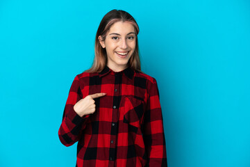 Young caucasian woman isolated on blue background with surprise facial expression