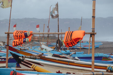 Buoys dried by fishermen on boat masts