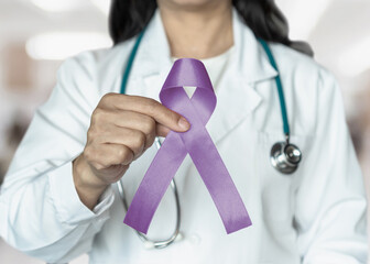 Orchid purple (lavender) ribbon awareness in doctors hand for (all kinds cancers), Testicular...