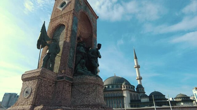 Istanbul, Turkey - December 28, 2023 - Republic Monument and Taksim Mosque can be seen in Taksim Square in Istanbul. The camera moves from the monument towards the mosque.