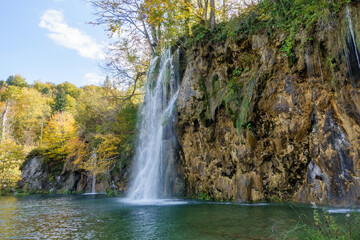 Fototapeta premium Waterfall in the woods at autumn season