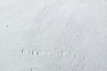 Plastered beige surface with cement material. Textured pattern with space for text. Texture of old gray concrete wall for background. Calm neutral spa background. 