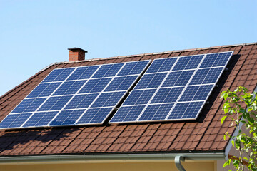 Naklejka premium Solar panels on the roof of a house