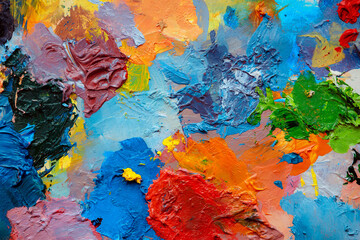 Colorful abstract texture. Smears of oil paint and a palette knife on an art palette. The concept of the modern school of art. Fragment of creative work. Colors of the year 2025