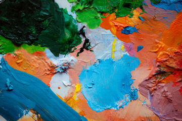 Colorful abstract texture. Smears of oil paint and a palette knife on an art palette. The concept...