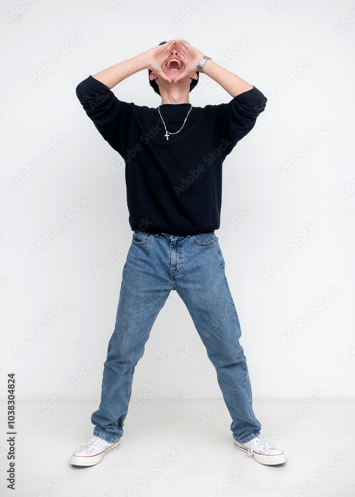 Wall mural full body photo of a young asian man in casual black shirt and jeans isolated on a white background,