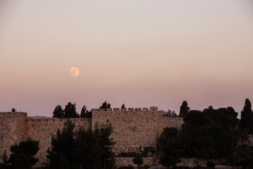 Full moon rise over the ancient walls and ramparts of the Old City of Jerusalem, Israel. © Yehoshua Halevi