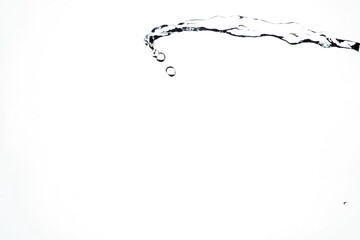 Water splash isolated on blue background. Transparent realistic water with movement and drops. Dynamic flight of water drops.