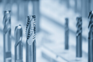 Close-up scene the group of new rough cutter end mill tool in the light blue scene.