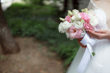 Wedding bouquet in the hands of the bride at the ceremony. Touching the hands of the bride and...
