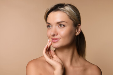 Cosmetology. Beautiful woman with perfect skin on beige background