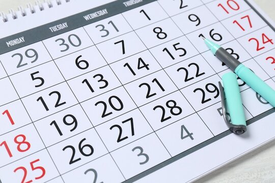 Timetable. Calendar and pen on table, closeup