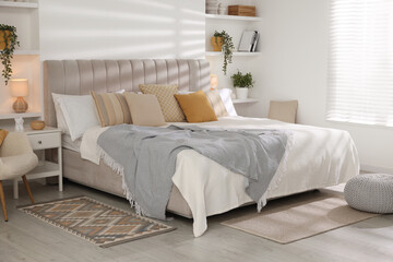 Comfortable large bed in beautiful room. Interior design
