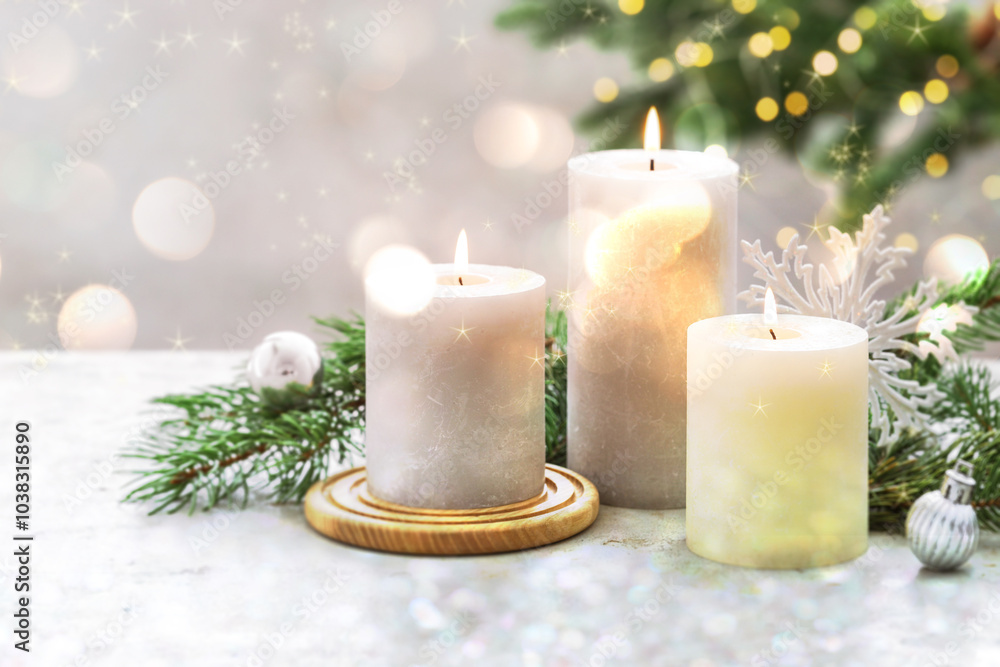 Wall mural Christmas composition with burning candles on white table, bokeh effect. Festive card