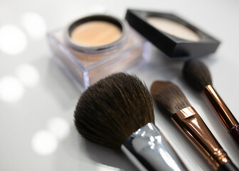 Makeup brushes and powder on a white table, close-up