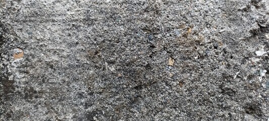Rough Dark Concrete Surface with Fine Details. Close-up of a textured dark concrete surface with small stones, perfect for industrial backgrounds