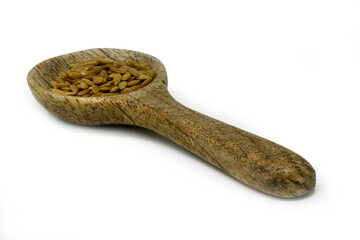 Golden Flaxseeds on a small wooden spoon isolated against a white background
