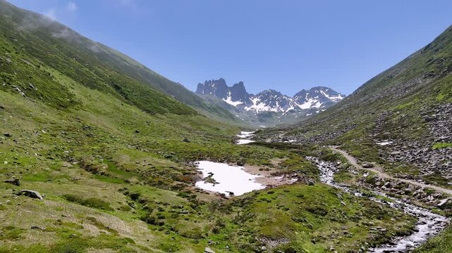 beautiful scenic ladscape in kackar mountain snowy and greenery meadow with a little river