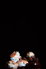Easter cake on the festive table. Festive baked goods with exuberant spring colors on a dark background. Chocolate candies on melted shiny chocolate.