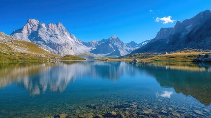 Fototapeta premium Serene Mountain Lake with Clear Reflection and Blue Sky