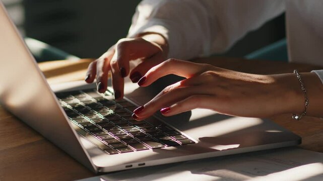 Female hands typing on laptop keyboard. Unknown busy businesswoman emailing to client remotely using digital wireless portable device. Girl fingers typing computer working learning messaging. 