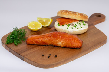 Delicious Savoury Salmon Bagel Featuring Fresh Dill and Accompanied by Zesty Lemon Wedges