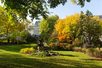 Fototapeta premium The Inuksuk monument on the National Assembly Square seen during a colourful sunny fall day, with the parliament in the background, Quebec City, Quebec, Canada